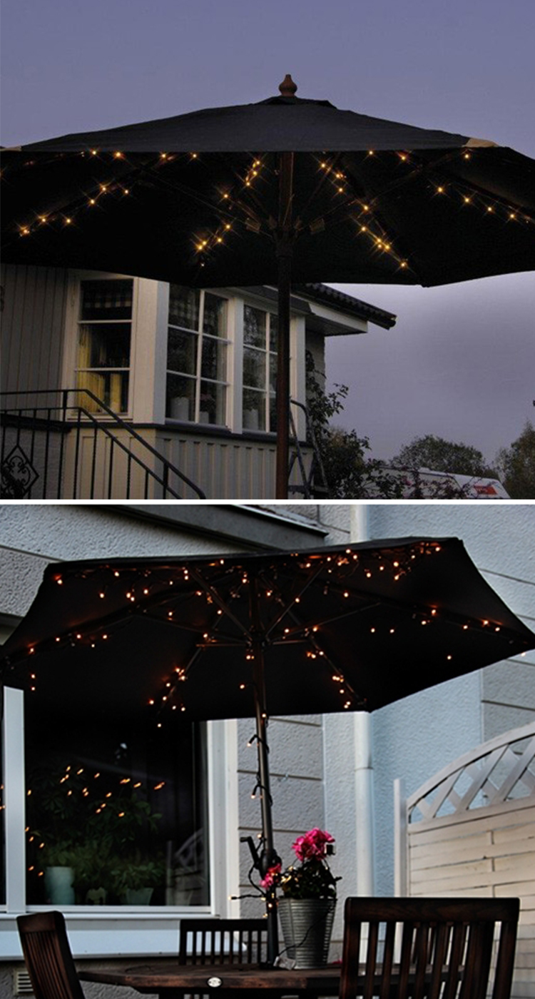 Mysiga sommarkvällar med belysning under parasollet